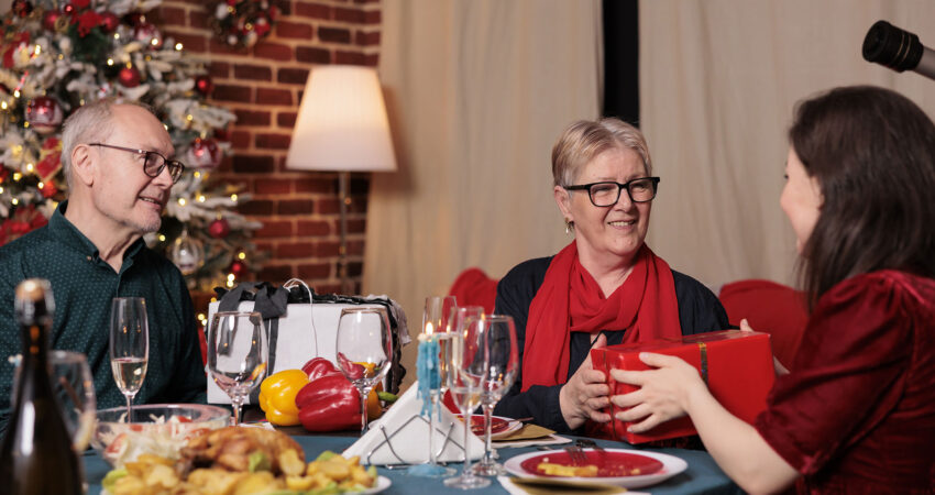 holiday party eating dinner and exchanging gifts in a clean home