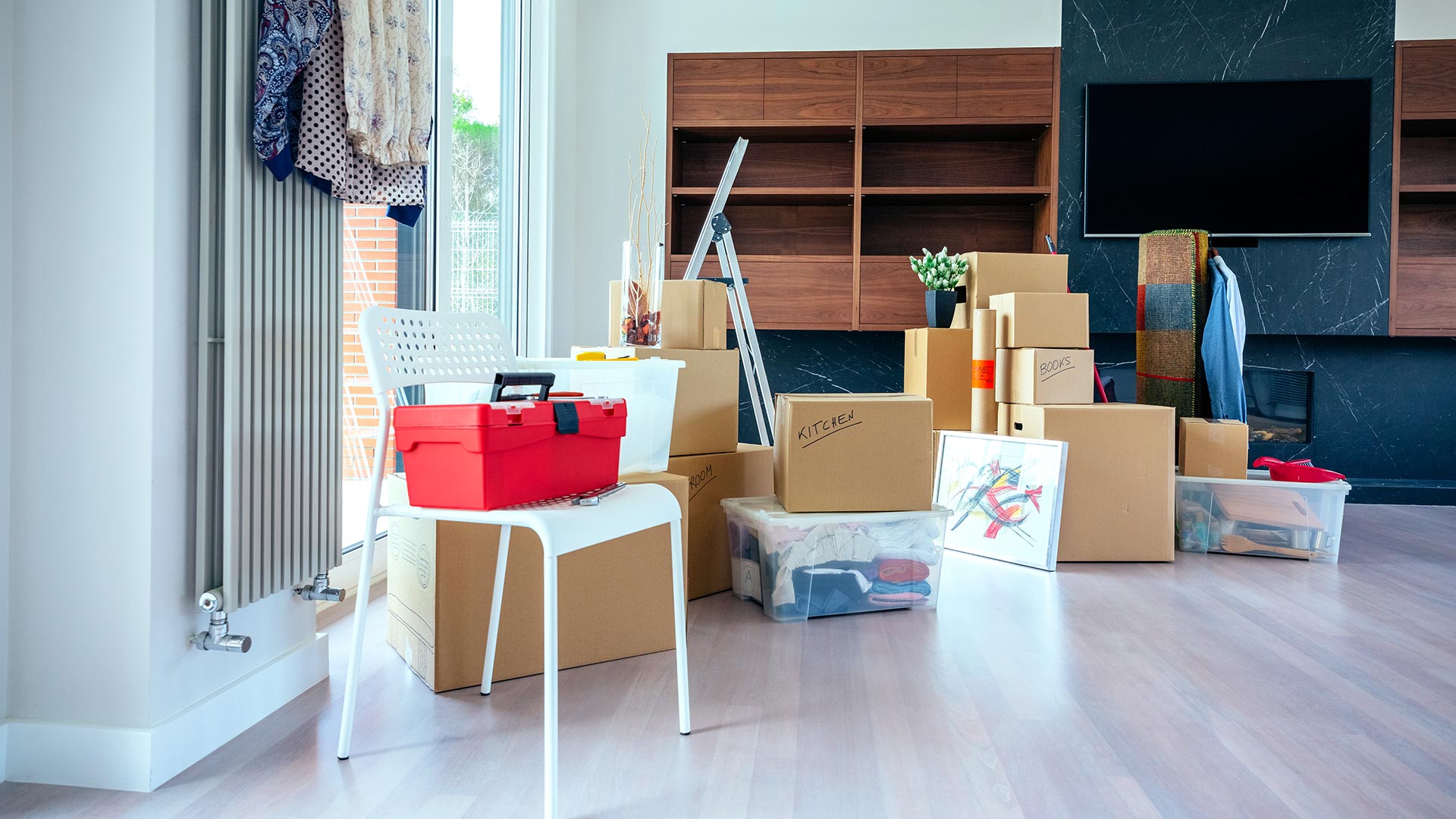 boxes piled up in clean living room after packing to move out